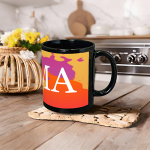 Custom black mug with a colorful “MAMA” print, displayed on a wooden kitchen countertop.