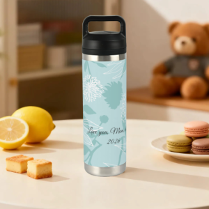 Custom water bottle with a light blue floral “Love you, Mom” print, displayed on a kitchen table with lemon and macarons.