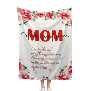Custom blanket with a Mother’s Day “MOM We love you” floral print, held by hands.