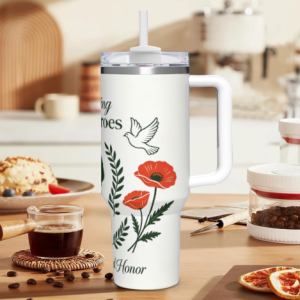 40oz Memorial Day handle tumbler with "Honoring Our Heroes" print, featuring red poppies, a dove, and "Remember and Honor" text, shown in a kitchen setting.