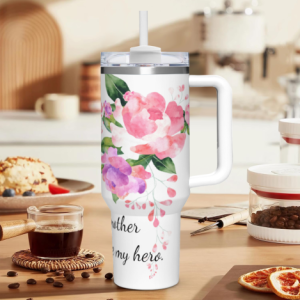 White 40oz large-capacity tumbler with handle, featuring a watercolor pink floral print and the text “mother is my hero.”, perfect as a Mother’s Day gift.