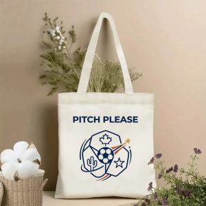 Front view of a beige canvas tote bag with a minimalist 2026 World Cup design. Features the "PITCH PLEASE" text above a geometric logo: a central soccer ball, Canadian maple leaf, Mexican cactus, USA star, and a shooting star accent, styled with cotton stems and dried botanicals.