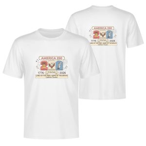 White double-sided print t-shirt celebrating America's 250th anniversary (1776-2026), featuring a whimsical cartoon-style "250" graphic with the Liberty Bell, bald eagle, and quill pen, paired with "AMERICA 250" and "LAND OF THE FREE, HOME OF THE BRAVE" text.