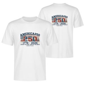 White double-sided print t-shirt celebrating America's 250th anniversary (1776-2026), featuring a vintage-style "250" graphic with the American flag, city skyline, and fireworks, paired with "AMERICA 250" and "LAND OF THE FREE, HOME OF THE BRAVE" text.