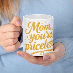 A white 11oz ceramic coffee mug held in hands, featuring "Mom, you're priceless" in vibrant golden cursive text with small heart accents.