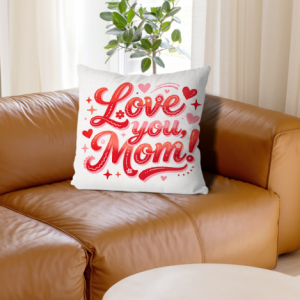 White linen throw pillow cover with "Love you, Mom!" print, red gradient cursive lettering with heart, star and floral accents, home decor for Mother’s Day