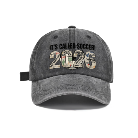 Dark grey vintage washed adjustable dad hat with retro newspaper‑collage 2026 number print and bold “It’s Called Soccer!” slogan, North America 2026 World Cup casual soccer fan baseball cap