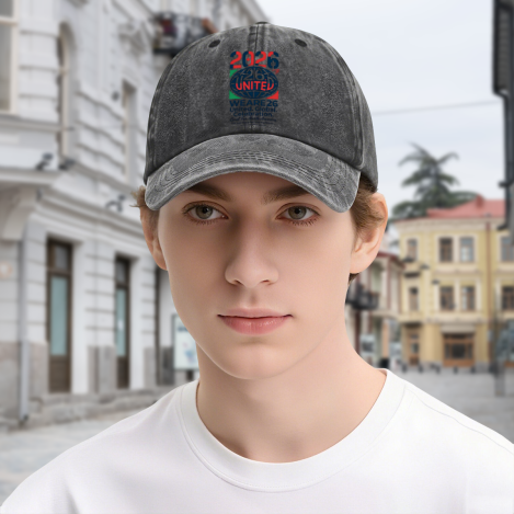 Young man wearing dark grey vintage washed stacked 2026 United soccer‑graphic dad hat, outdoor street‑style portrait of 2026 North America World Cup soccer fan