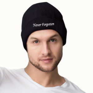 Memorial Day "Never Forgotten" beanie worn on a model, showing the classic black knit design with white embroidered text.