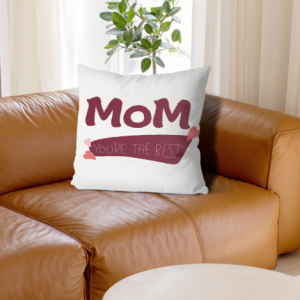 White linen throw pillow cover with "MOM You're The Best" print, maroon bold lettering with pink heart accents, home decor for Mother’s Day