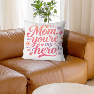 White linen throw pillow cover with "Mom, you're my hero" print, pink-to-orange gradient cursive lettering with floral and heart accents, home decor for Mother’s Day