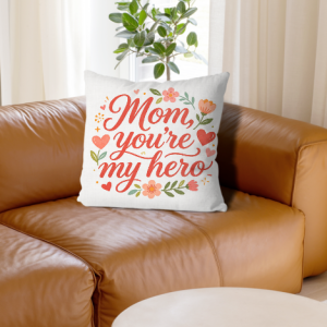 White linen throw pillow cover with "Mom, you're my hero" print, red cursive lettering with floral and heart accents, home decor for Mother’s Day