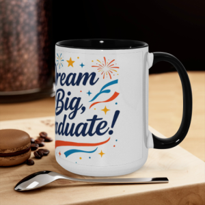 "Dream Big, Graduate!" mug on a kitchen counter, with colorful fireworks print and black handle, ready for coffee or tea.