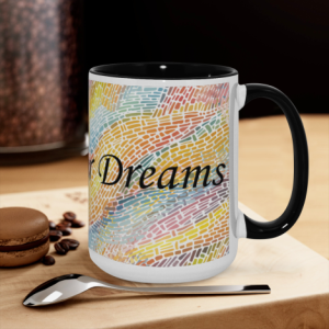 "Chase Your Dreams" mug on a kitchen counter, with colorful mosaic print and black handle, ready for coffee or tea.