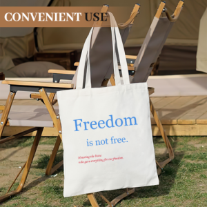 Memorial Day tote bag on an outdoor camping chair, showcasing the "Freedom is not free" print in a casual setting.