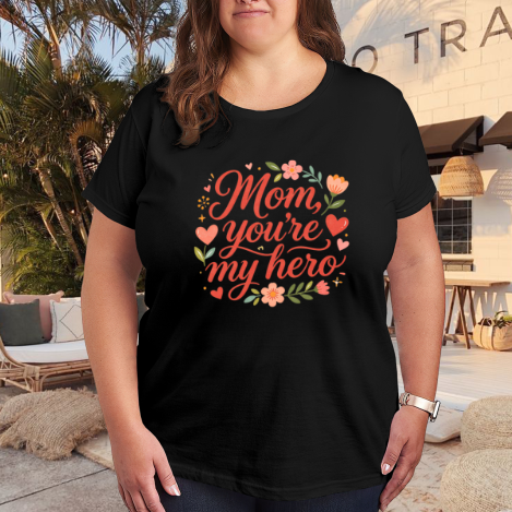 Plus size black women’s t-shirt with "Mom, you're my hero" heart and floral print, casual crewneck tee styled for outdoor patio wear