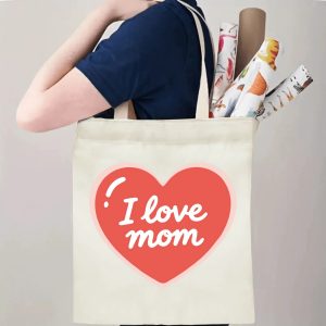 A person carrying the "I love mom" heart print canvas tote bag over their shoulder, showing its comfortable straps and roomy design with rolled papers inside.
