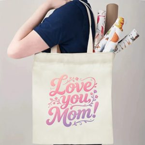 A person carrying the "Love you, Mom!" print canvas tote bag over their shoulder, showing its comfortable straps and roomy design with rolled papers inside.