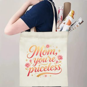 A person carrying the "Mom, you're priceless" print canvas tote bag over their shoulder, showing its comfortable straps and roomy design with rolled papers inside.