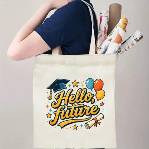 Person carrying natural canvas graduation tote bag with "Hello, future" celebratory print, graduation cap and balloon graphics, casual milestone‑celebrating reusable gift bag