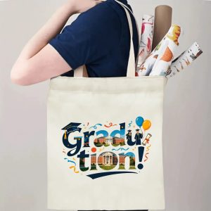 Person carrying natural canvas graduation tote bag with unique campus‑inspired "Graduation!" print, graduation cap and celebratory balloon graphics, casual milestone‑celebrating reusable gift bag