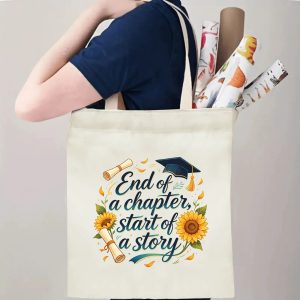 Person carrying natural canvas graduation tote bag with sunflower‑framed milestone quote print, graduation cap and diploma graphics, casual keepsake reusable gift bag