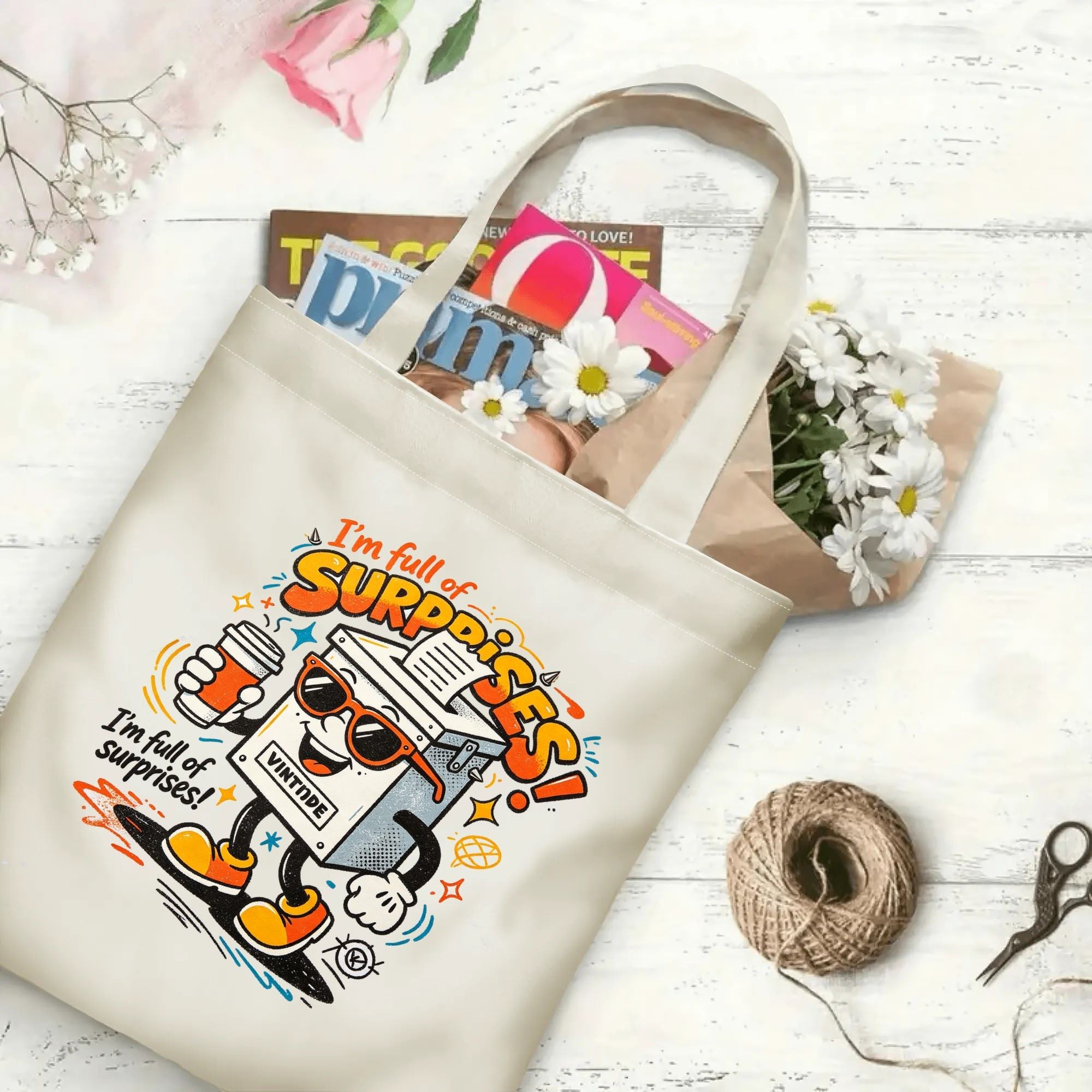 Flat‑lay shot of natural canvas political novelty tote bag with colorful anthropomorphic ballot box graphic, fun typography and election‑themed quote, decorated with daisies, ideal casual daily‑wear bag for voters