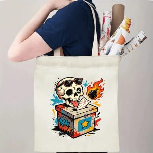 Person carrying natural canvas 2026 mid‑term election gag gift tote bag with bold street‑art skull ballot box design and edgy punk aesthetic, reusable political accessory for election rallies, voting day and everyday errands