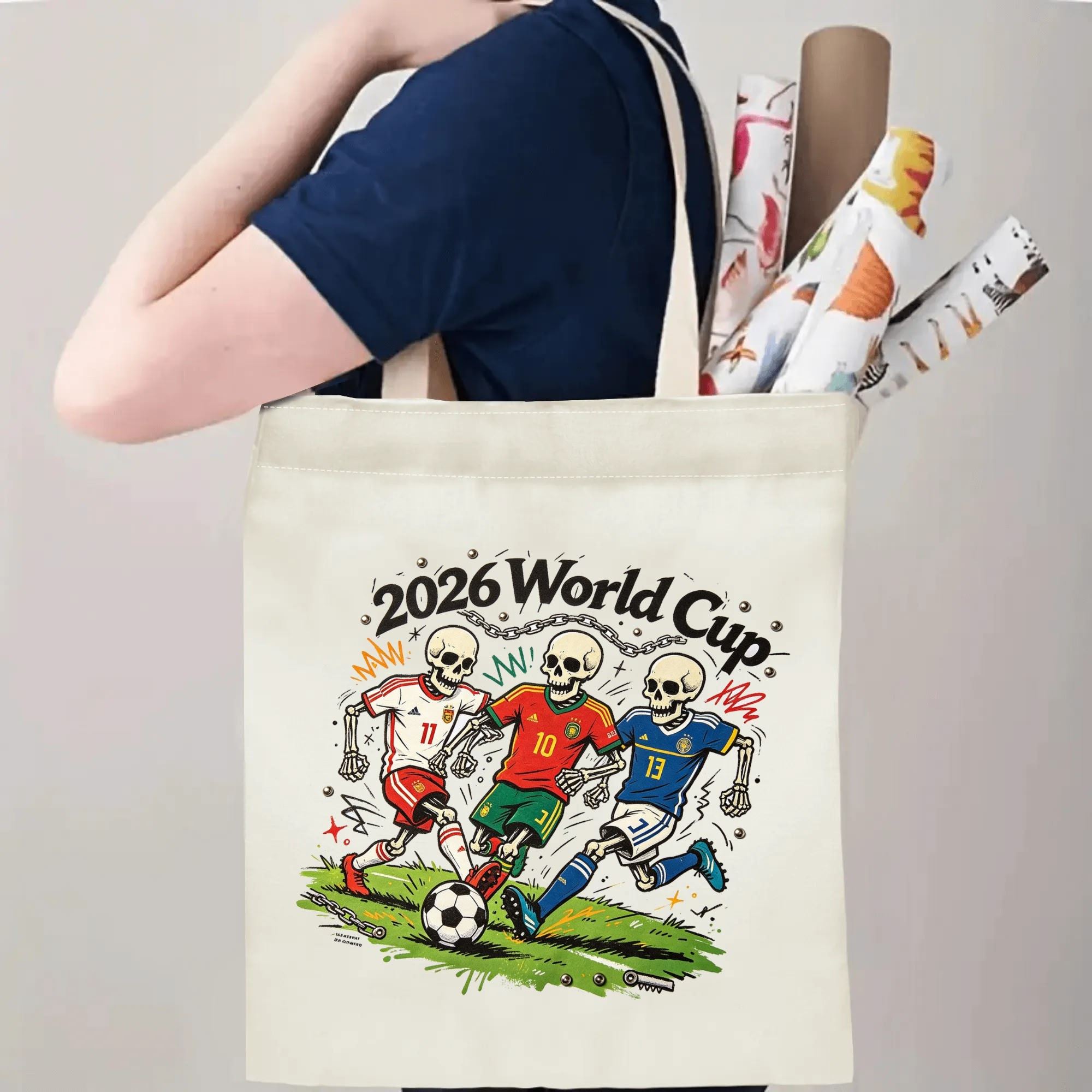 Person carrying natural canvas 2026 World Cup fan‑gift tote bag with rebellious tattoo‑art skeleton soccer team design, reusable sports accessory for tournament viewing, fan events or everyday errands