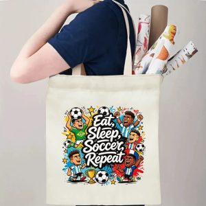 Person carrying natural canvas 2026 World Cup fan‑gift tote bag with energetic street‑cartoon soccer celebration design, reusable sports accessory for tournament viewing, fan events or everyday errands