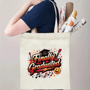 Person carrying a “Finally Graduated” music‑themed canvas tote bag over the shoulder, with rolled posters and graduation essentials.
