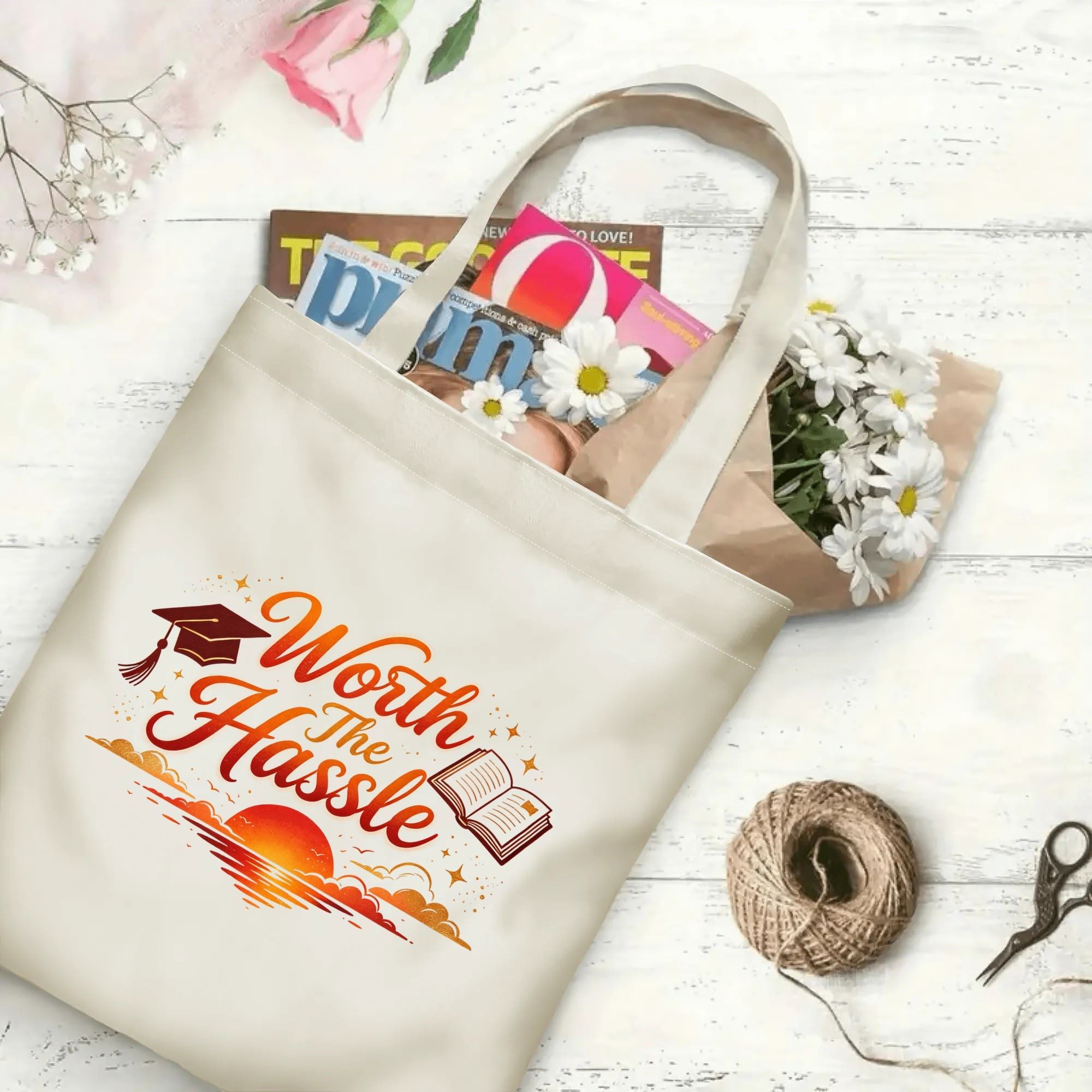 “Worth The Hassle” sunset‑themed canvas tote bag in use, holding books, flowers, and gifts.