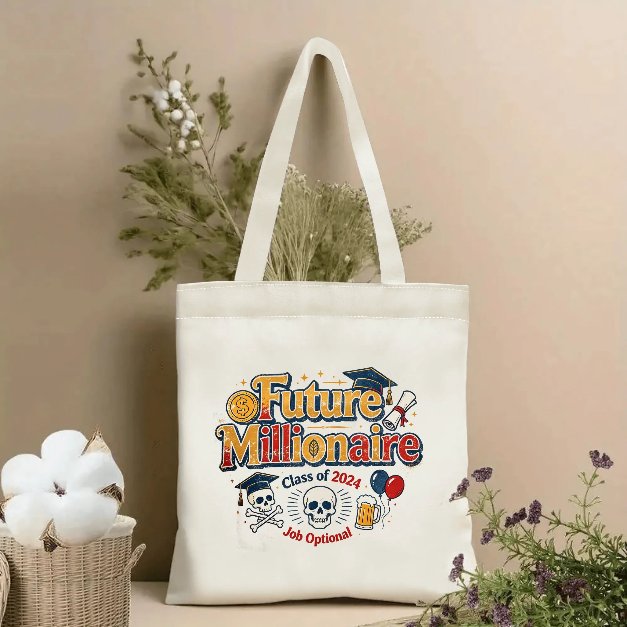 Natural canvas tote bag with “Future Millionaire Class of 2024” print, featuring graduation caps, skull graphics, a diploma, beer mug, balloons, and a playful “Job Optional” slogan.