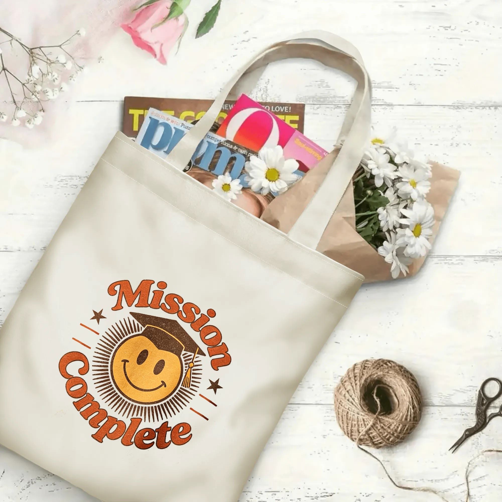 “Mission Complete” retro‑style canvas tote bag in use, holding books, flowers, and gifts.