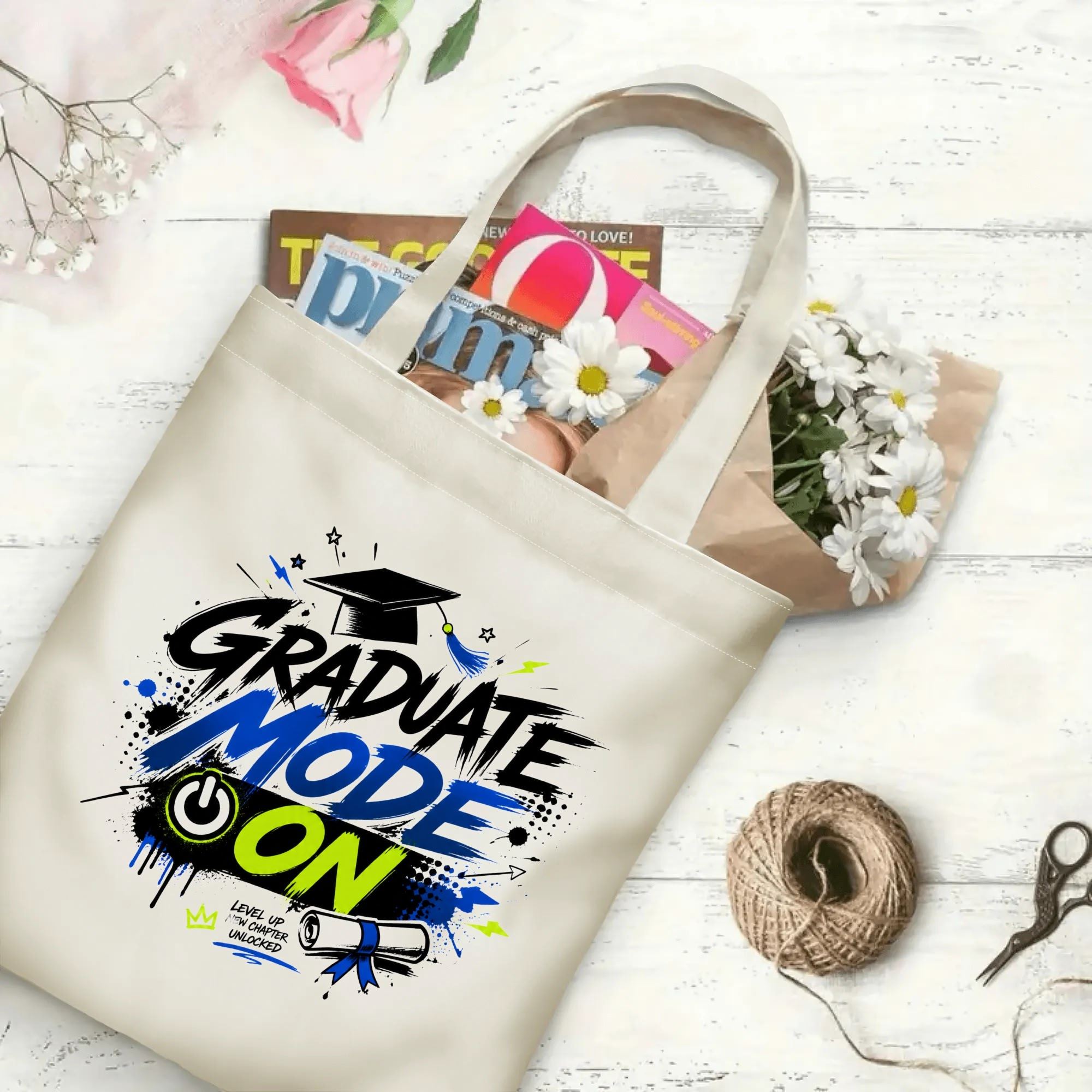 “Graduate Mode On” gamer-inspired canvas tote bag in use, holding books, flowers, and gifts.