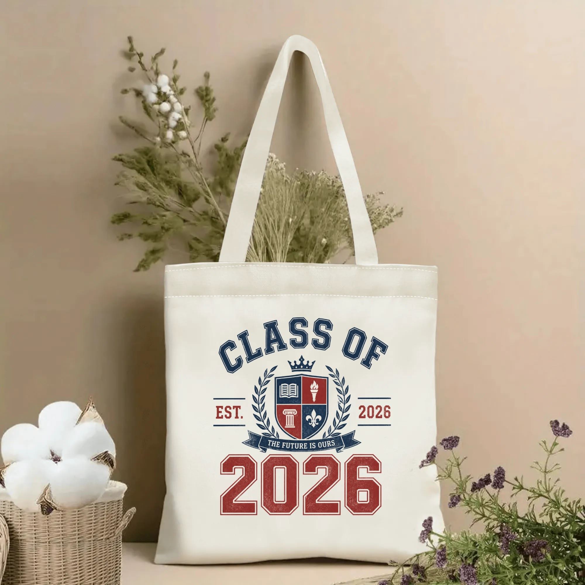 Natural canvas tote bag with “Class of 2026” print, featuring a vintage-style crest, laurel wreath, and the phrase “The Future Is Ours” in navy and red.