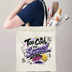 Person carrying a “Too Cool For School Class of 2026” graduation tote bag over the shoulder, with rolled posters and graduation essentials.