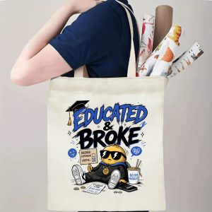 Person carrying an “Educated & Broke” graduation tote bag over the shoulder, with rolled posters and graduation essentials.