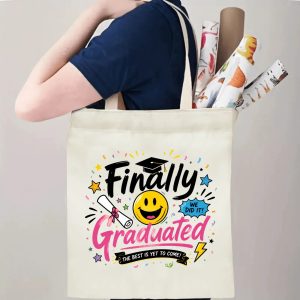 Person carrying a “Finally Graduated” graduation tote bag over the shoulder, with rolled posters and graduation essentials.
