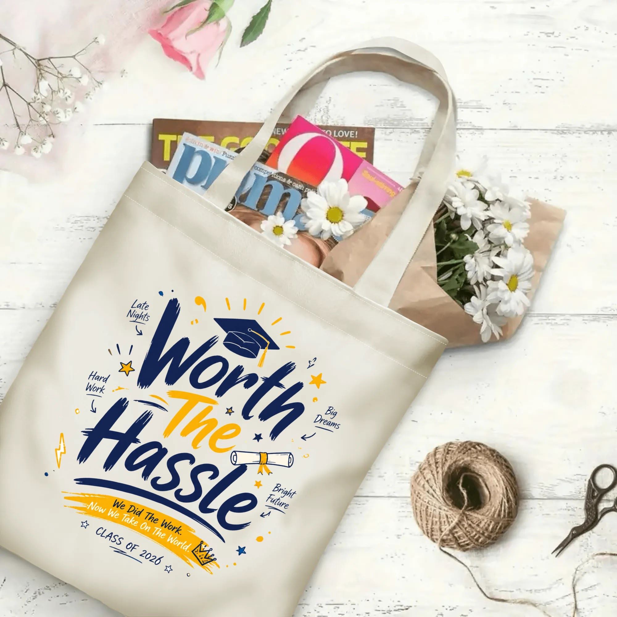 “Worth The Hassle Class of 2026” inspirational-style canvas tote bag in use, holding books, flowers, and gifts.
