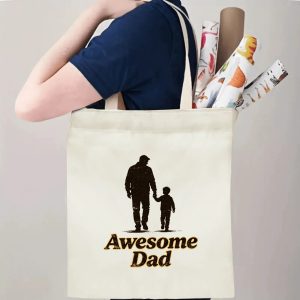 Person carrying an “Awesome Dad” Father’s Day tote bag over the shoulder, perfect for celebrating the quiet heroism of fatherhood.