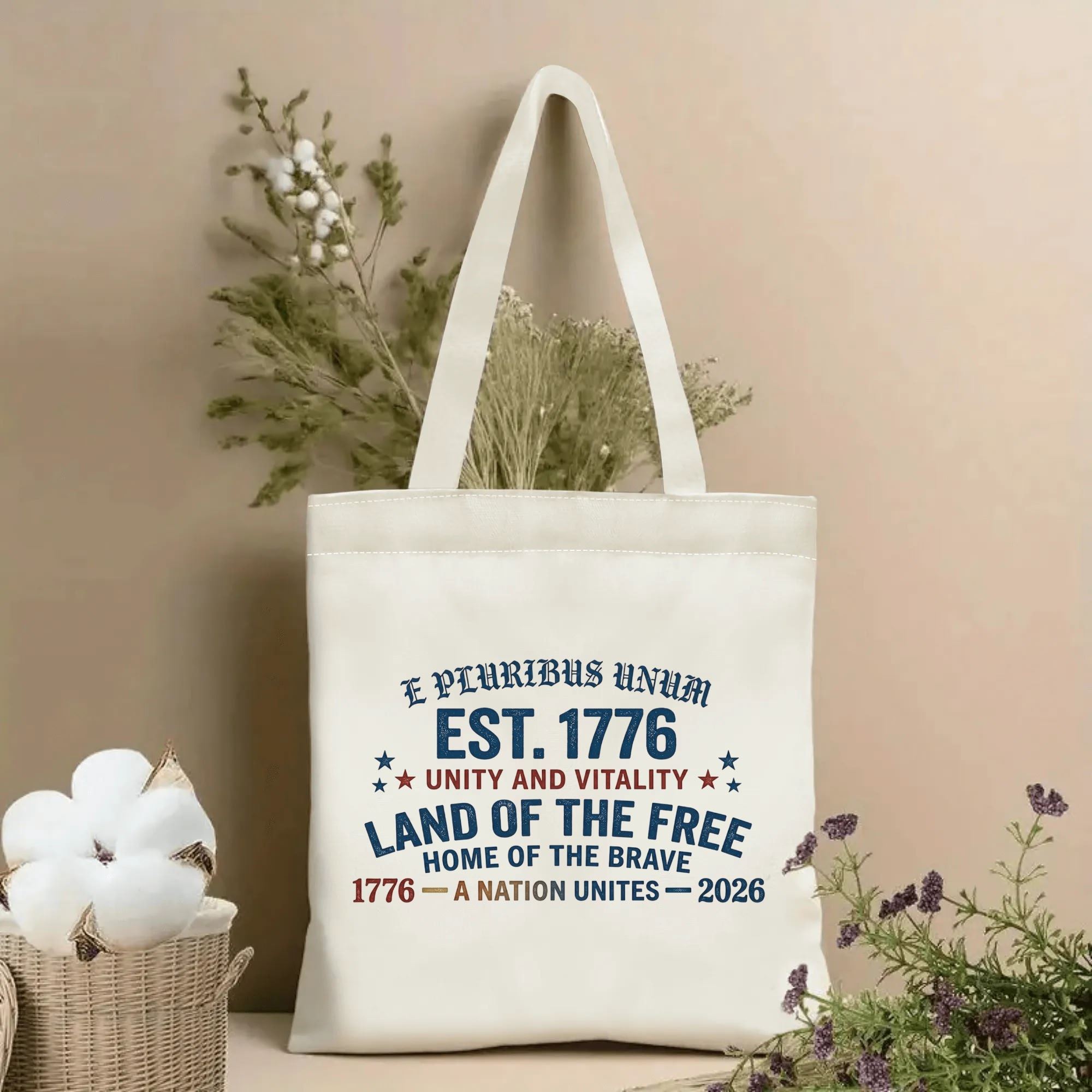 Natural canvas tote bag featuring the patriotic "E Pluribus Unum EST. 1776 Land of the Free 1776-2026" design, styled as a home decor piece.