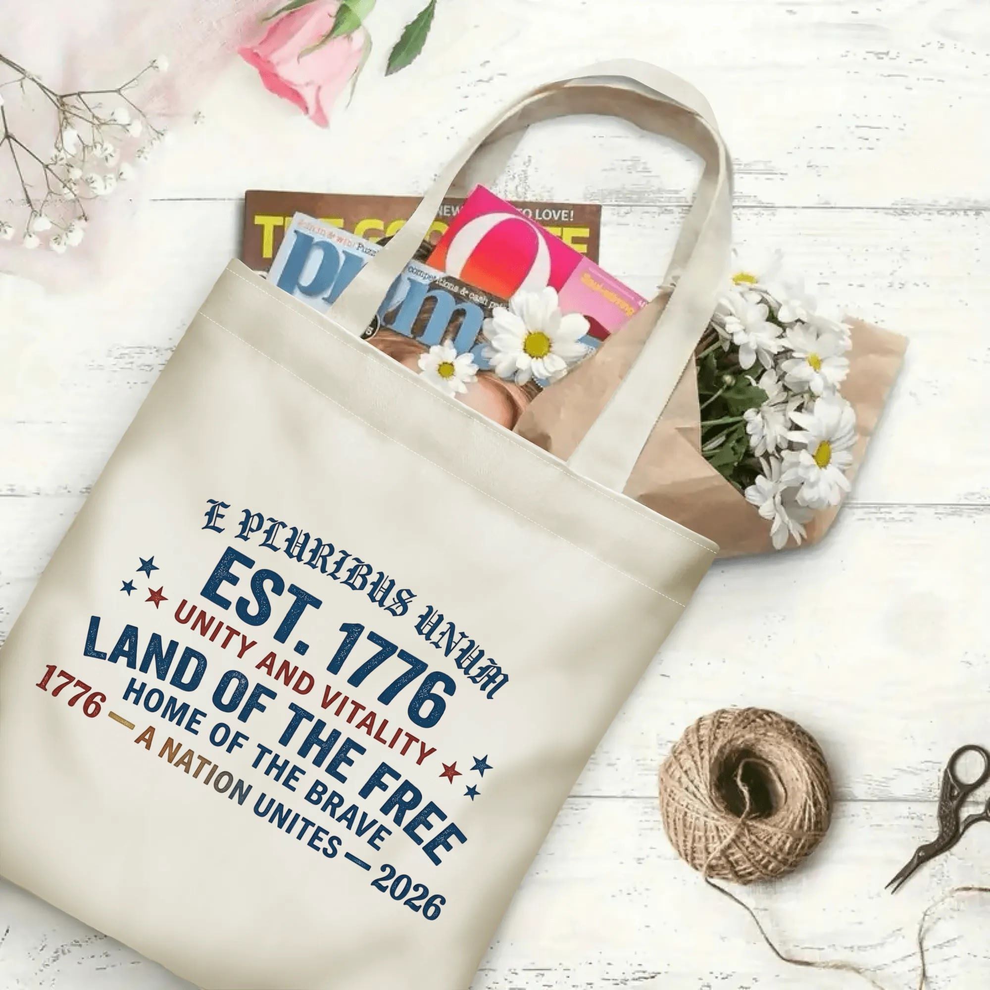 "Land of the Free" canvas tote bag filled with books and flowers, showcasing its spacious design for everyday use and patriotic events.
