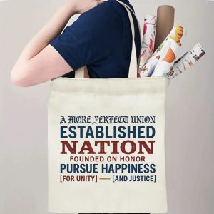 "A More Perfect Union" tote bag being carried by a person, demonstrating its comfortable straps and capacity for daily essentials or event items.