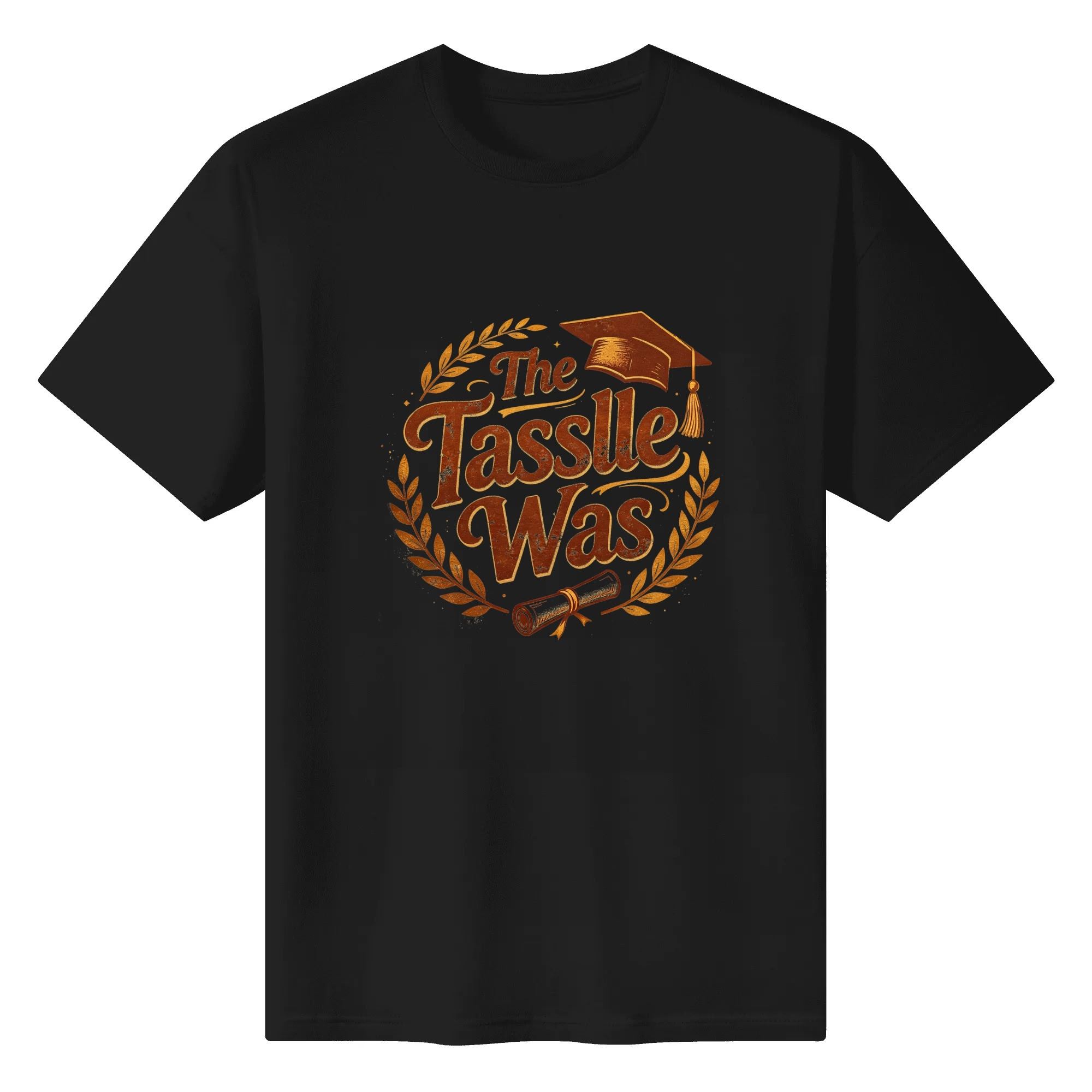 Black crewneck T-shirt with a vintage-style “The Tassle Was” graphic, featuring a distressed brown design, graduation cap, diploma, and laurel wreath.