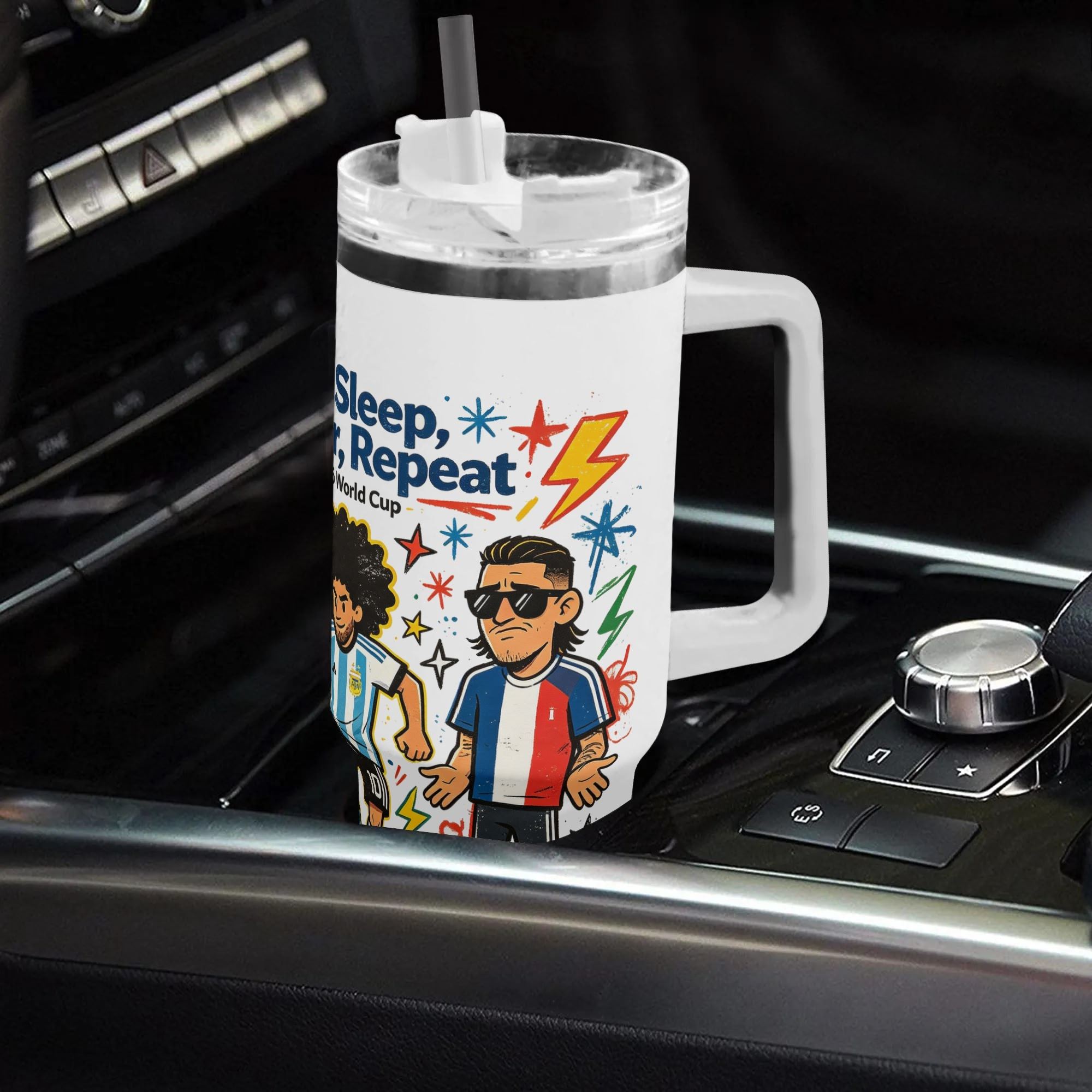 40oz stylish multi‑national‑team soccer themed insulated tumbler with handle placed on car center console, cool sunglasses‑wearing French footballer graphic with colorful splash details, leak‑proof straw lid, auto‑safe hot‑cold drink cup