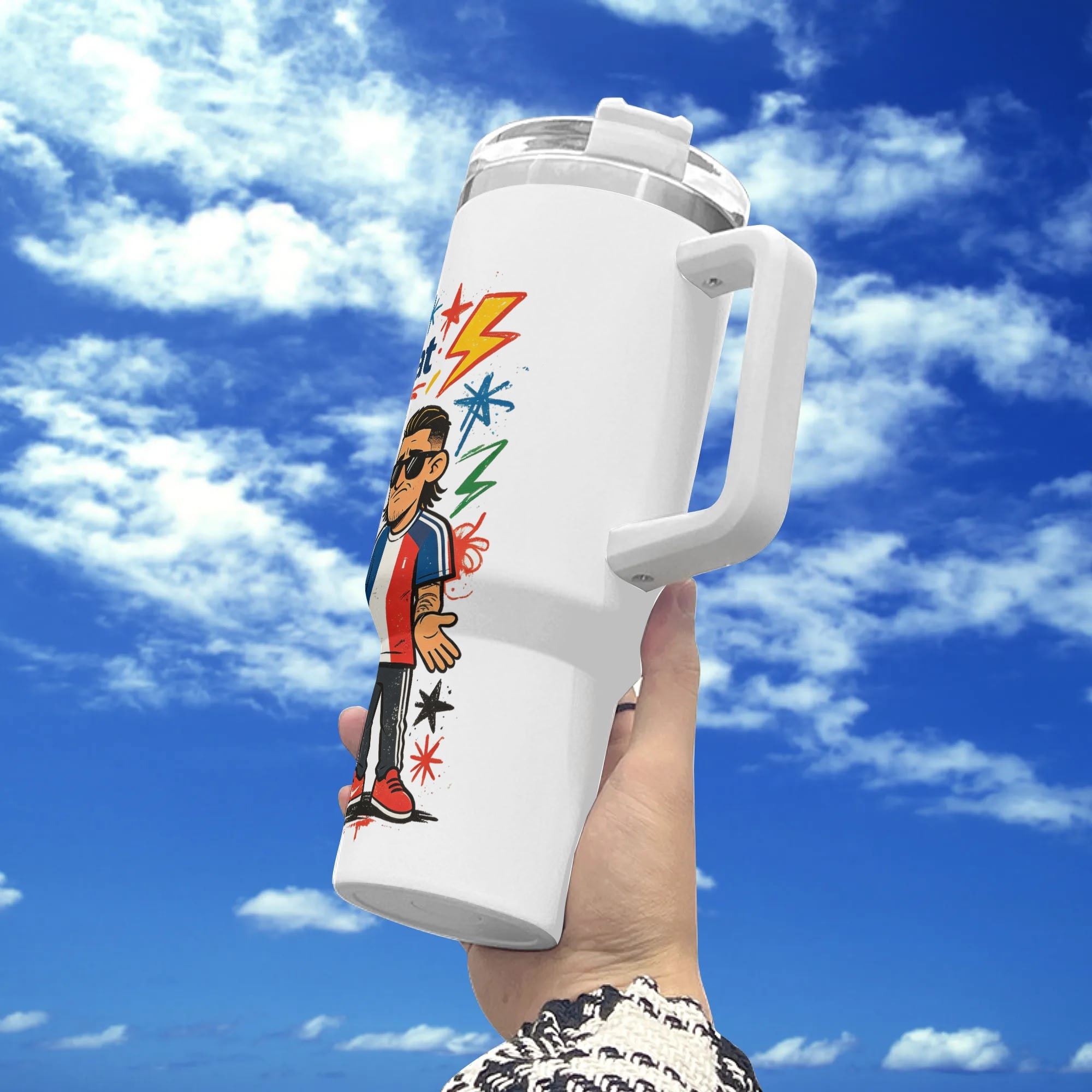 White 40oz insulated stainless steel tumbler with handle, cool pop‑comic France national team cartoon footballer with sunglasses print, held against blue sky background, stylish international soccer fan travel mug
