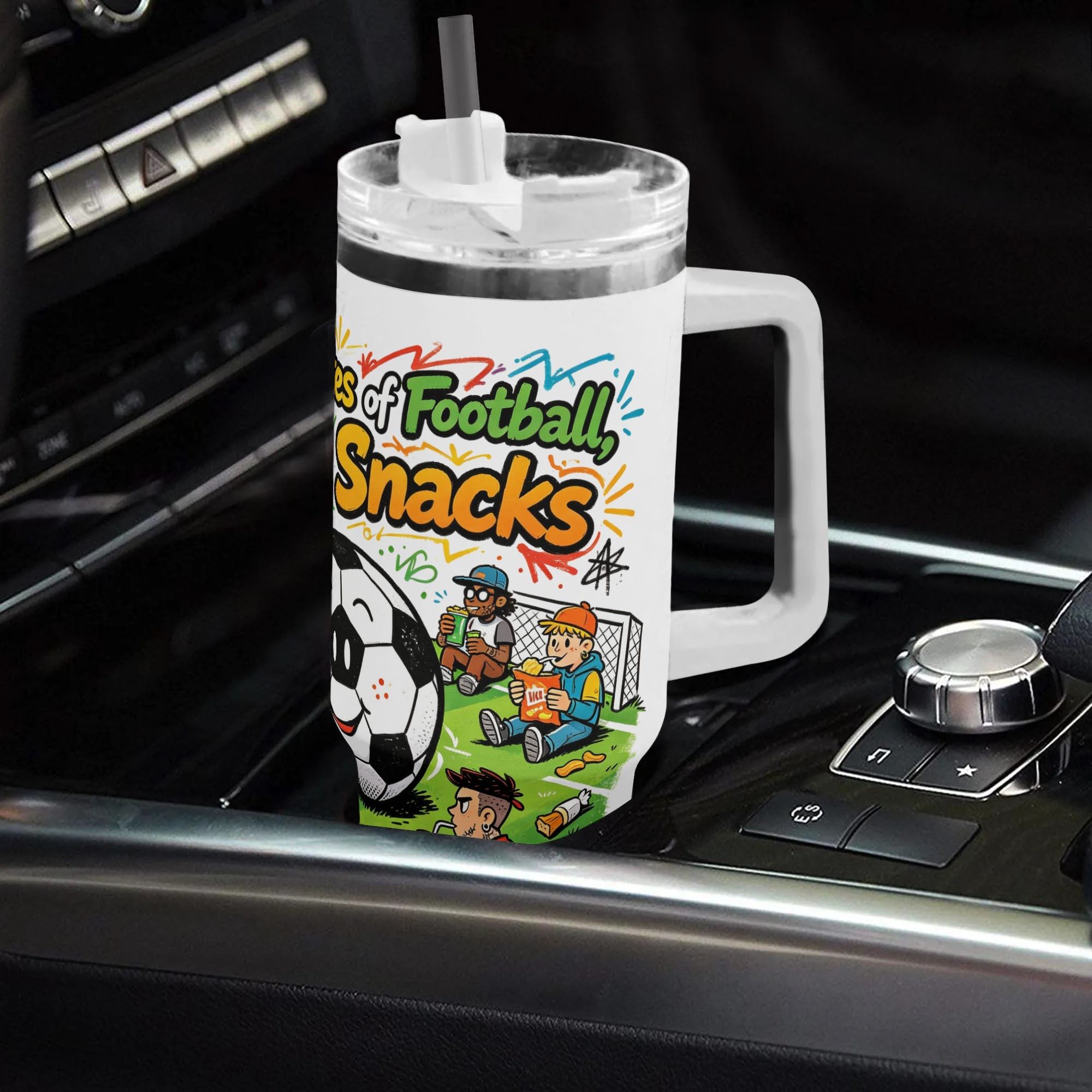 40oz lighthearted football‑snack‑culture themed insulated tumbler with handle placed on car center console, cute cartoon soccer‑fan‑snack graphic with vibrant doodle details, leak‑proof straw lid, auto‑safe hot‑cold drink cup