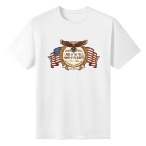 White unisex cotton short‑sleeve t‑shirt, front luxurious ornate circular‑badge patriotic print celebrating America’s 250‑year milestone, featuring majestic bald eagle, waving American flag, golden laurel detailing and freedom‑themed anniversary text, refined heritage‑focused commemorative tee flat lay