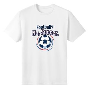 White oversized cotton short‑sleeve t‑shirt, front sporty curved‑font “Football? No, Soccer.” graphic print with classic soccer ball and red‑blue speed‑line ring details, casual pro‑soccer sports‑themed tee flat lay